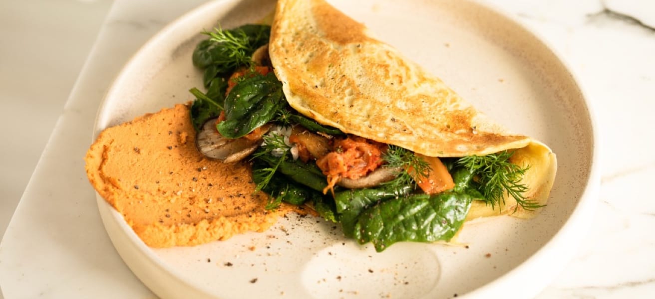 A delicious omelette served with greens.